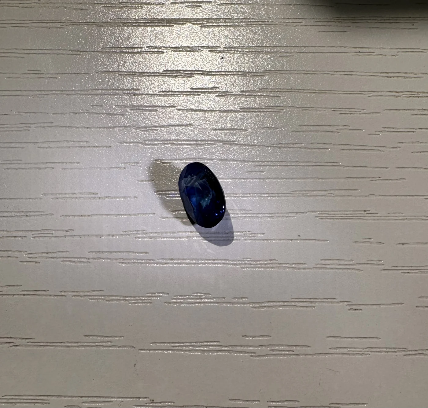 Serial 103 oval Sri Lankan blue sapphire under light