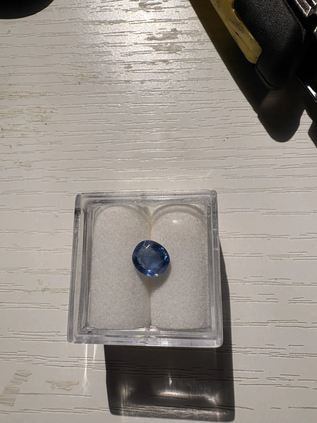 Serial 104 oval Sri Lankan blue sapphire in a display box