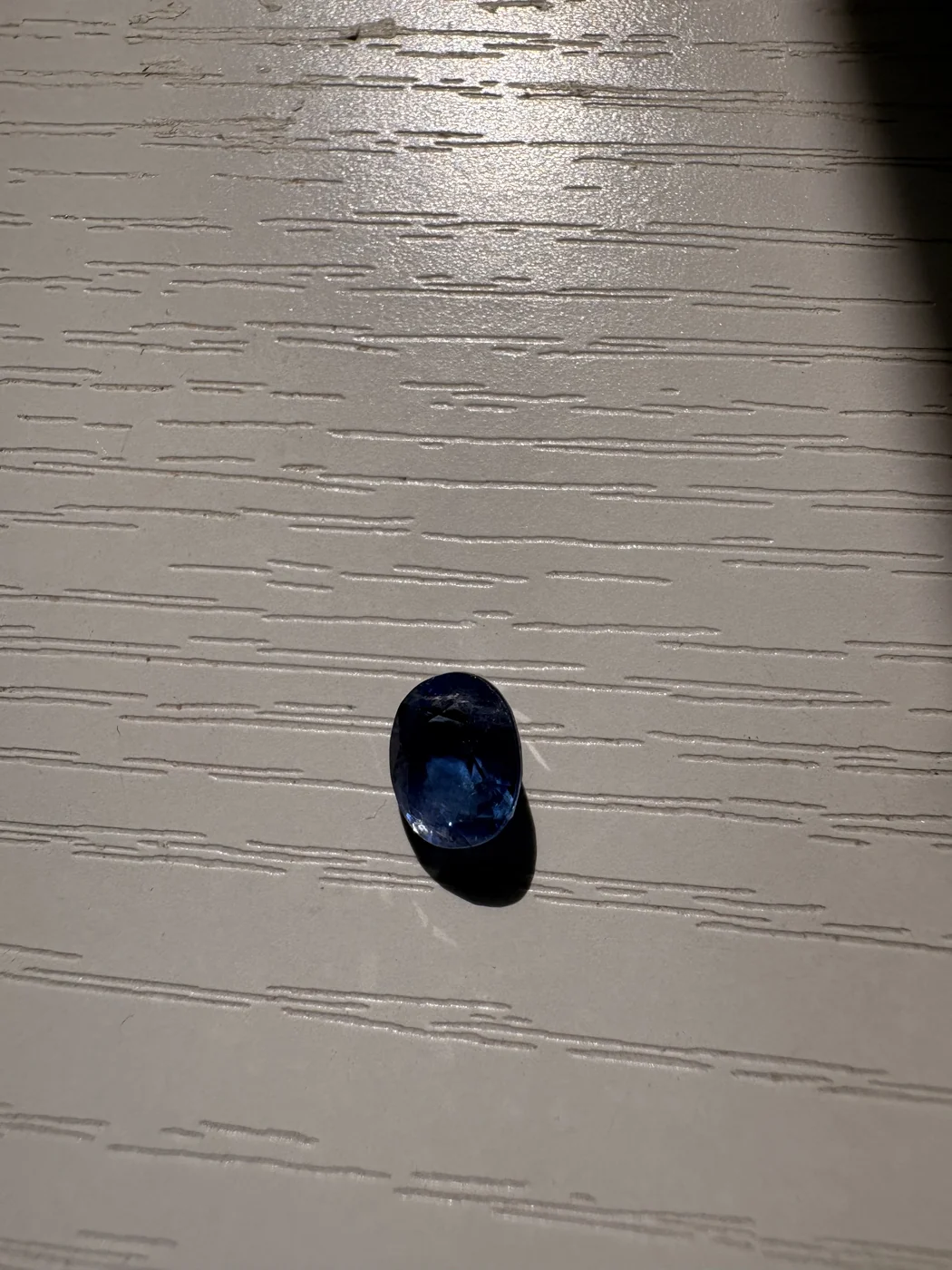 Serial 104 oval blue sapphire under light