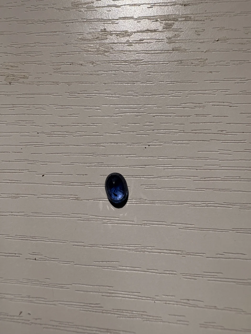 Serial 107 oval Sri Lankan blue sapphire under light