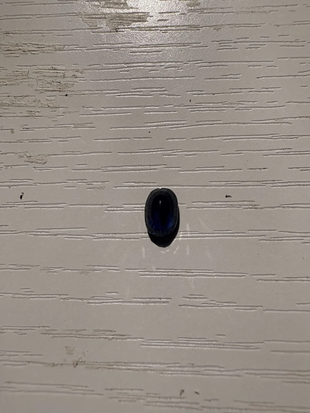 Serial 108 oval Sri Lankan blue sapphire under light