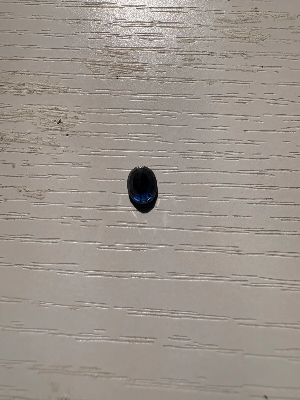 Serial 111 oval Sri Lankan blue sapphire under light