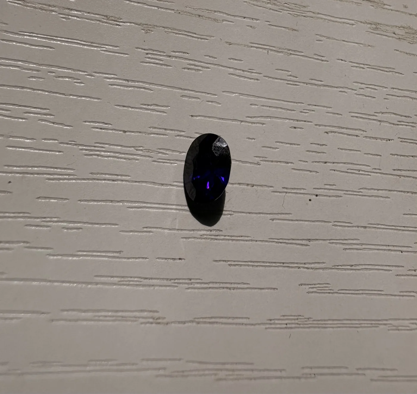 Close view of serial 105 violetish-blue oval sapphire